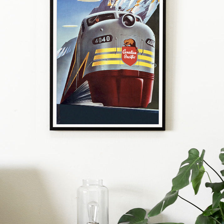 Canada travel poster, showing a train in a winter landscape with snowy hills in the background